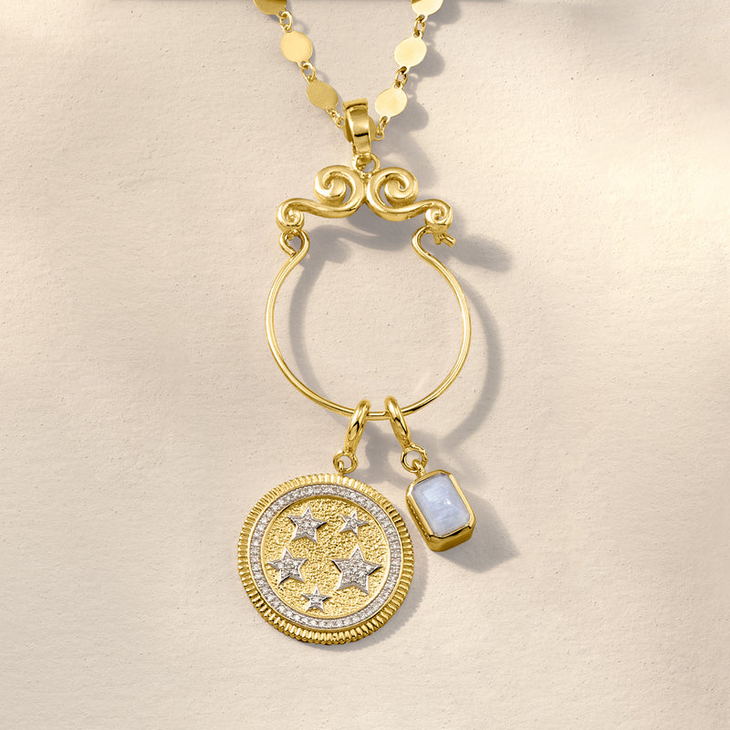 Gold tone necklace with round disc charm and small square emerald-cut stone
