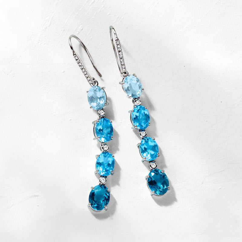 Sterling silver earwire drop earrings featuring sky blue topaz ovals with diamond details