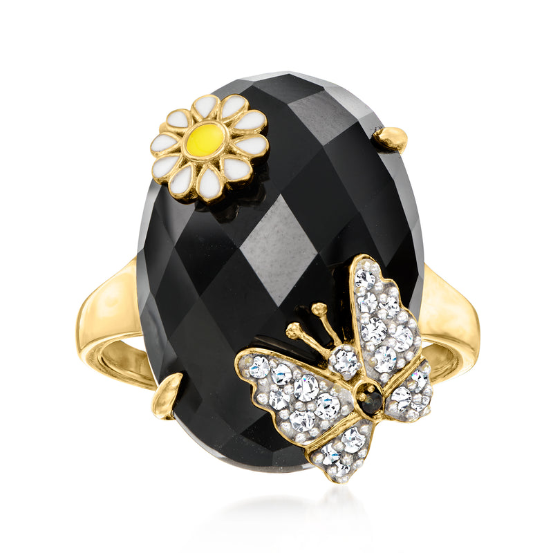 Gold-tone ring with large black faceted oval stone, white zircon flower and bow detail