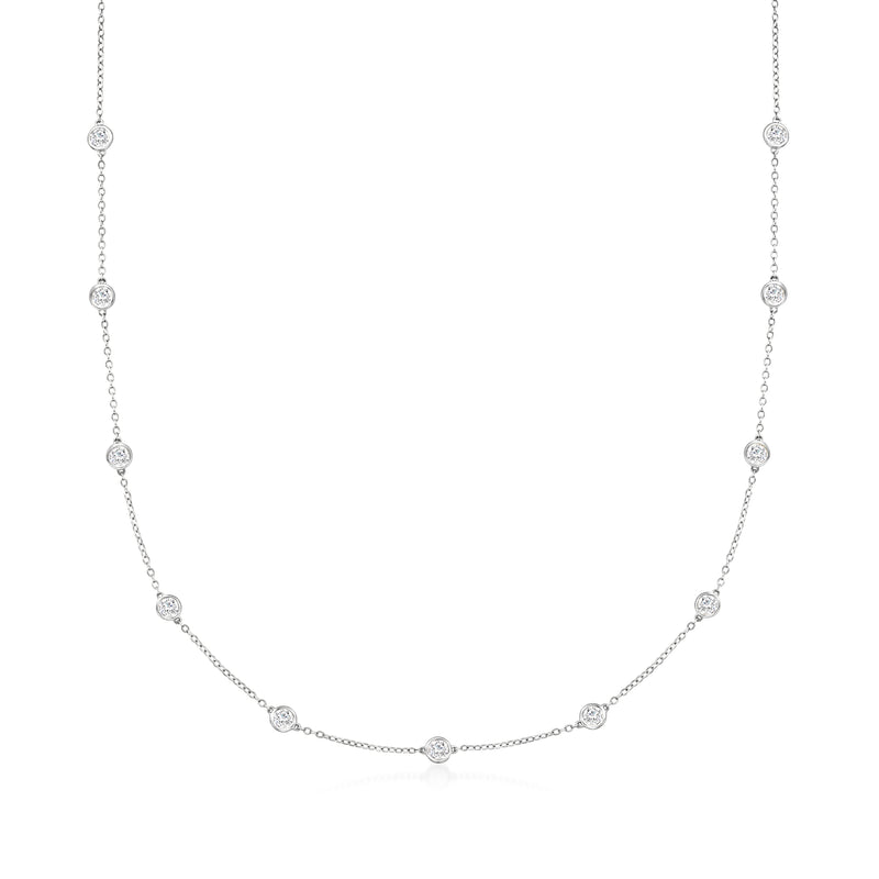 Diamond station necklace with round bezel-set stones on white gold chain, full view.