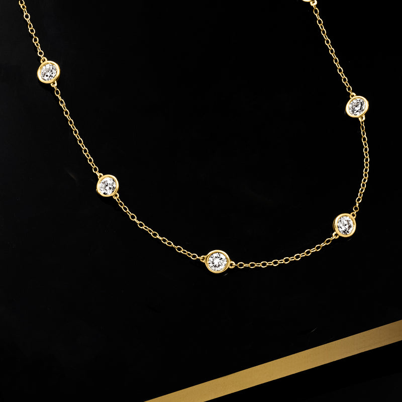 14kt yellow gold diamond station necklace with round bezel-set stones on fine chain