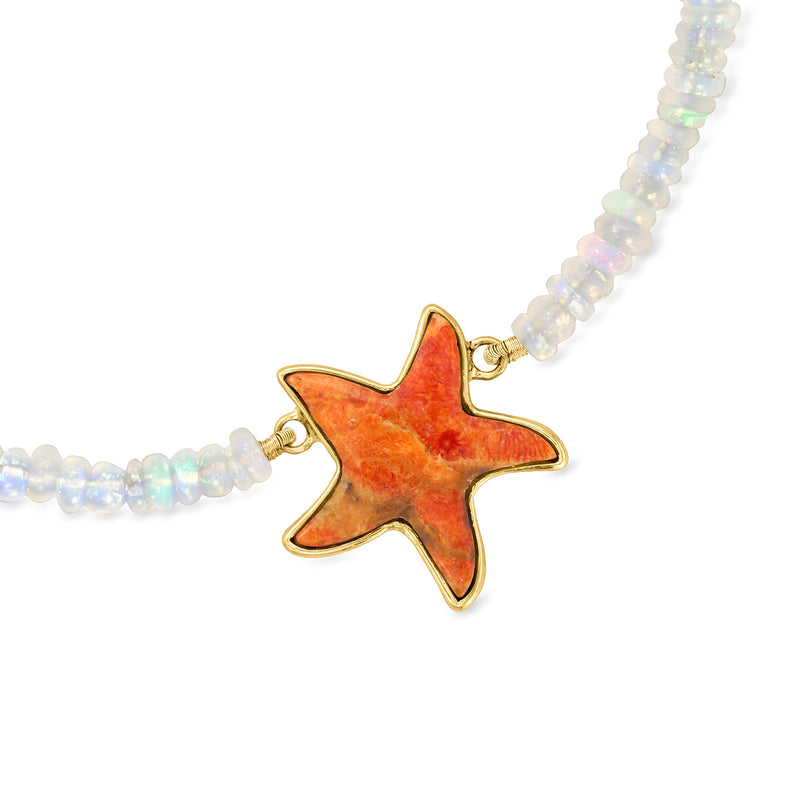 Opal bead necklace close-up with orange coral starfish pendant and gold clasp