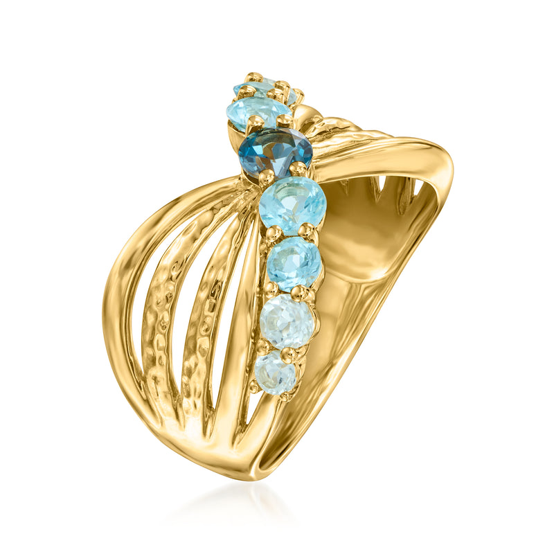 Gold bow ring with oval blue gemstones and multi-stone setting