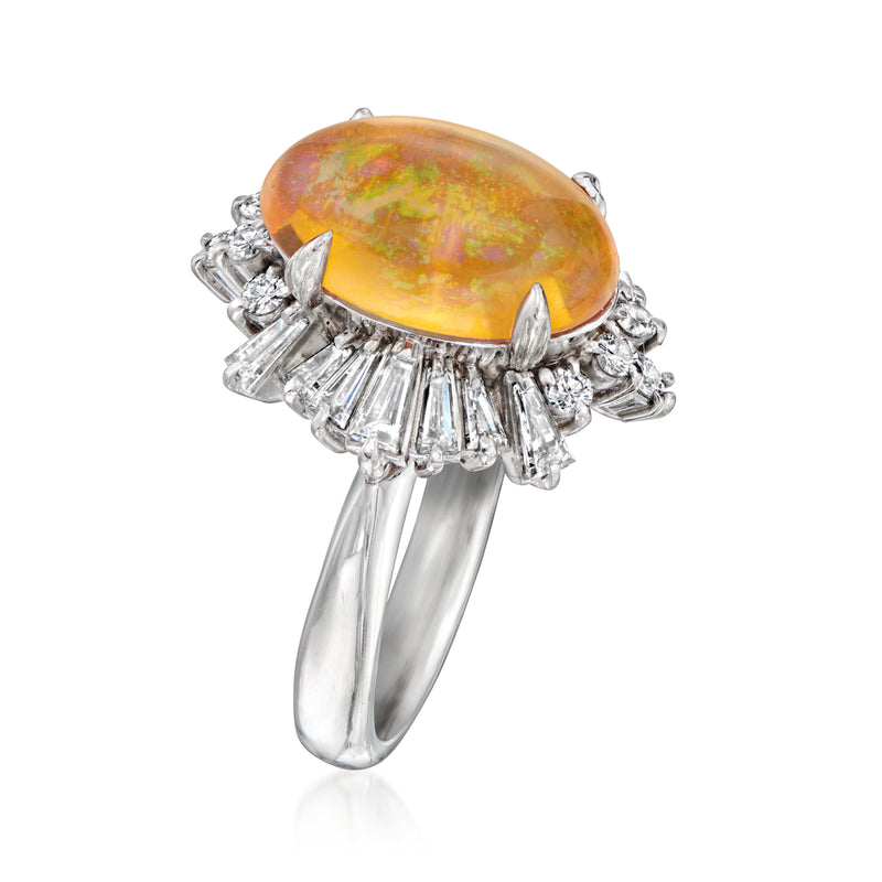 Platinum opal and diamond ring angled view, oval yellow-orange opal with diamond bar halo.