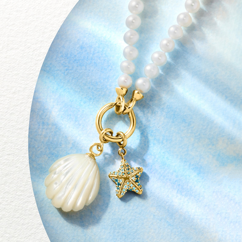 White cultured pearl necklace with gold ring clasp, shell drop and star charm