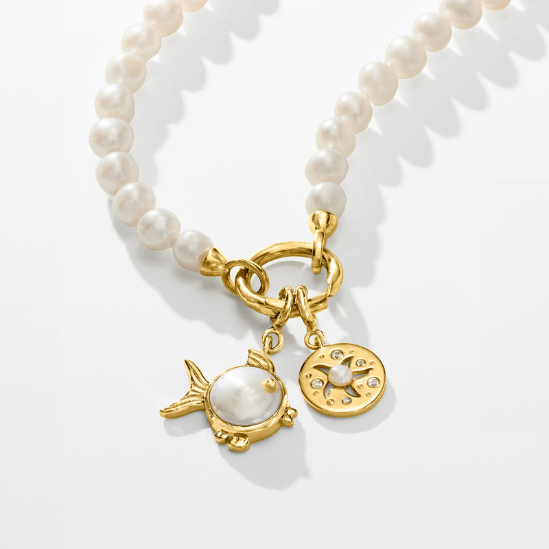White cultured pearl necklace with gold ring clasp and fish and moon charms