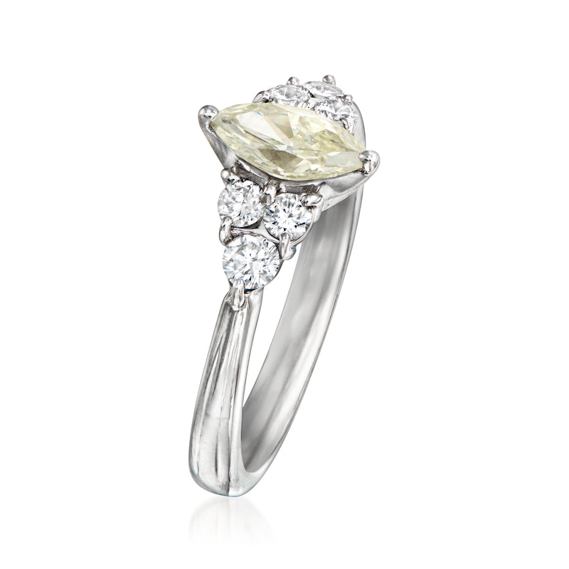 Vintage platinum diamond ring, side view with yellow oval center and clustered stones