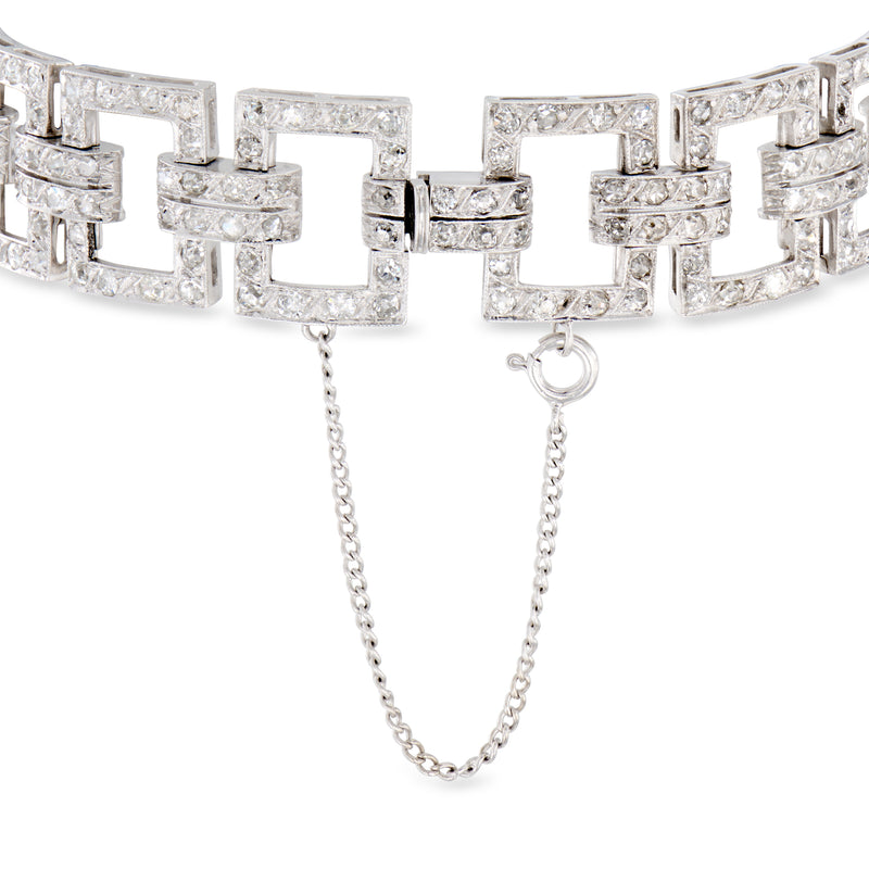 Platinum diamond geometric-link bracelet with square settings and dangling safety chains