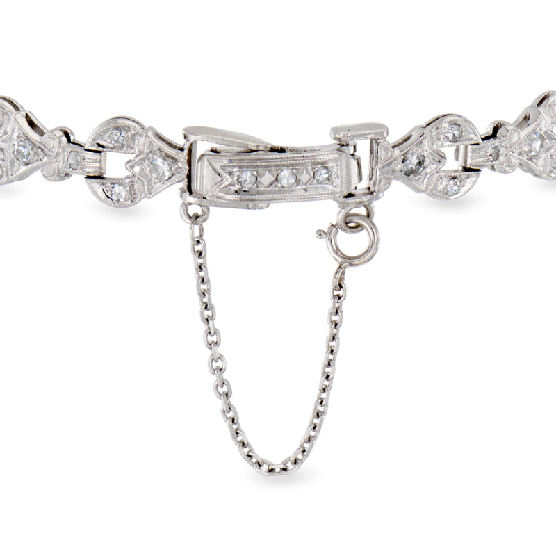 Platinum diamond bracelet clasp with dangling safety chain and round stones