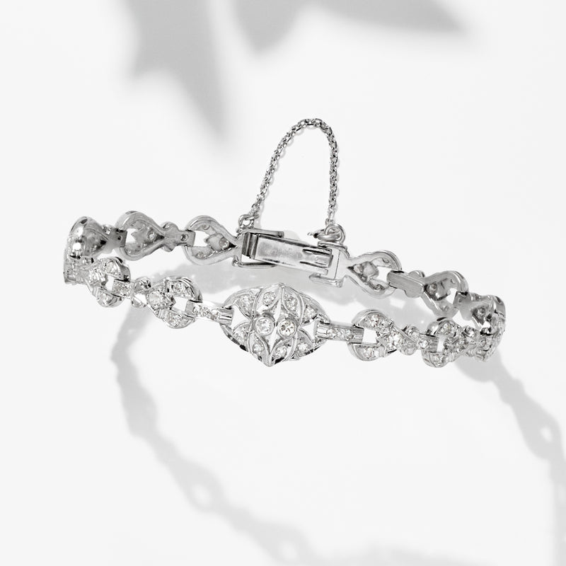 Platinum diamond tennis bracelet with marquise and round stone links, hinged top