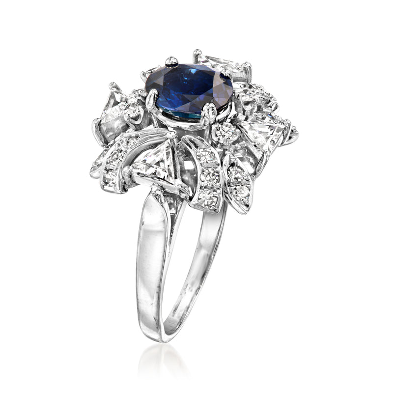 White gold ring with large blue center gemstone and diamond halo and side details