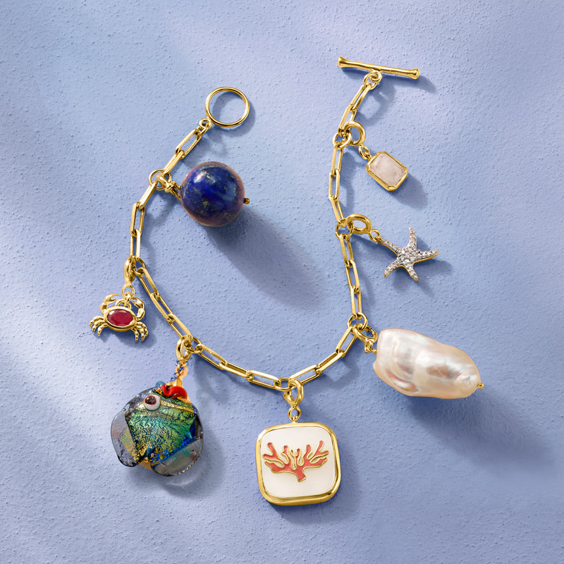Gold chain necklace with a small red crab charm pendant