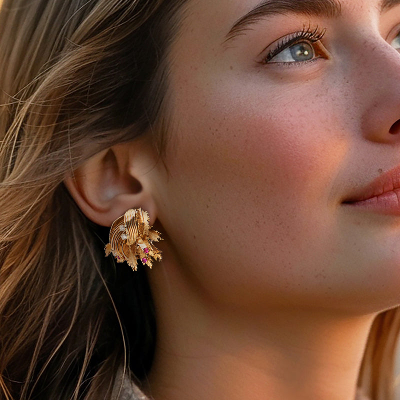 Gold leaf clip earrings with pink ruby stones and diamond sparkles on ear