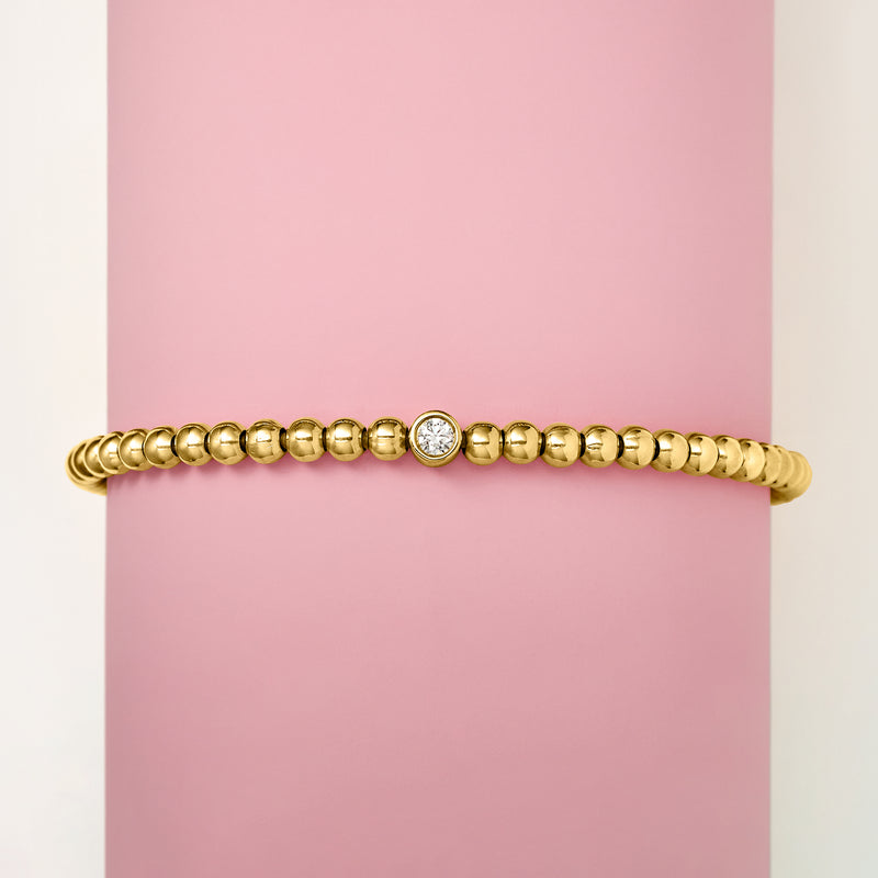 Gold bead stretch bracelet with single round lab-grown diamond on top