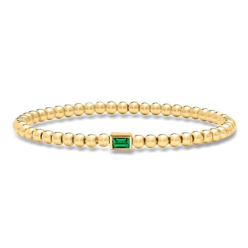 Gold bead stretch bracelet with emerald-green square gemstone center