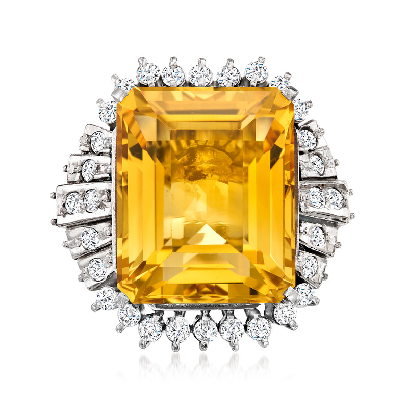 Platinum citrine cocktail ring with emerald-cut yellow gemstone and diamond halo