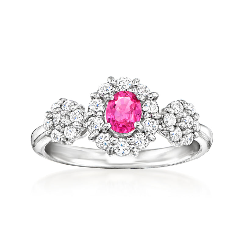 Platinum ring with oval pink sapphire center and diamond cluster halo