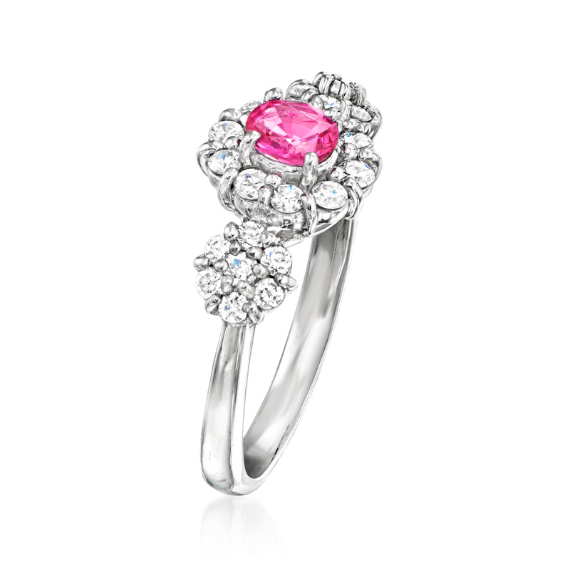 Platinum cluster ring with oval pink center stone and round diamonds, side view