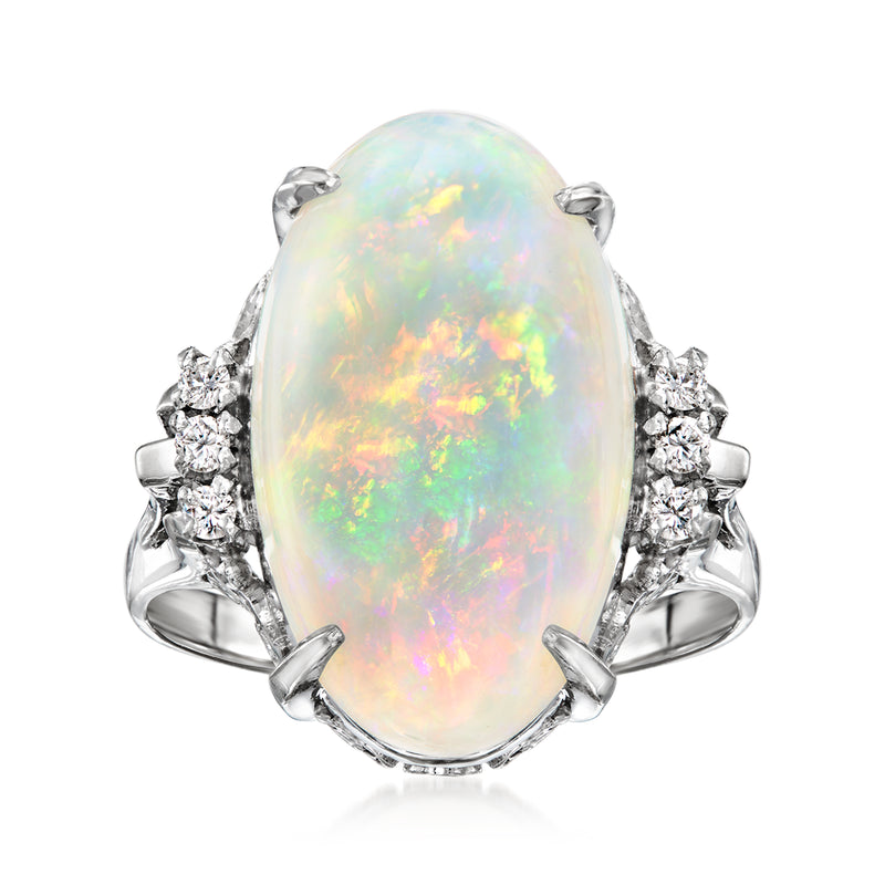 Oval opal cabochon ring in platinum with diamond side clusters
