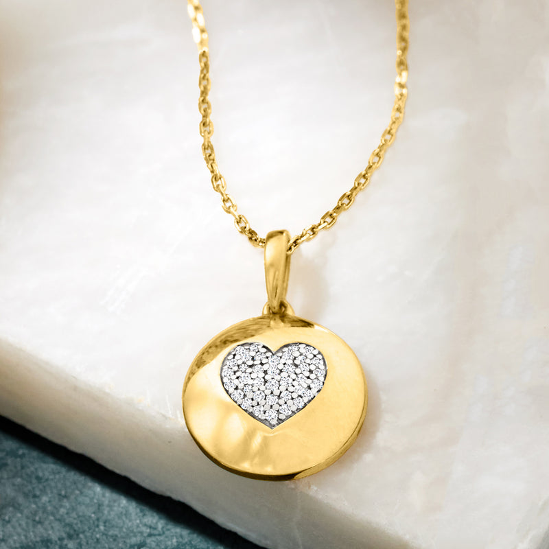 Gold round disc pendant necklace with sparkling diamond heart on chain