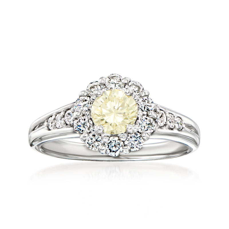 Platinum ring with oval yellow diamond and white diamond halo, round accents