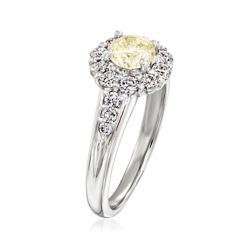 Side view of platinum ring with oval yellow center diamond and white diamond halo