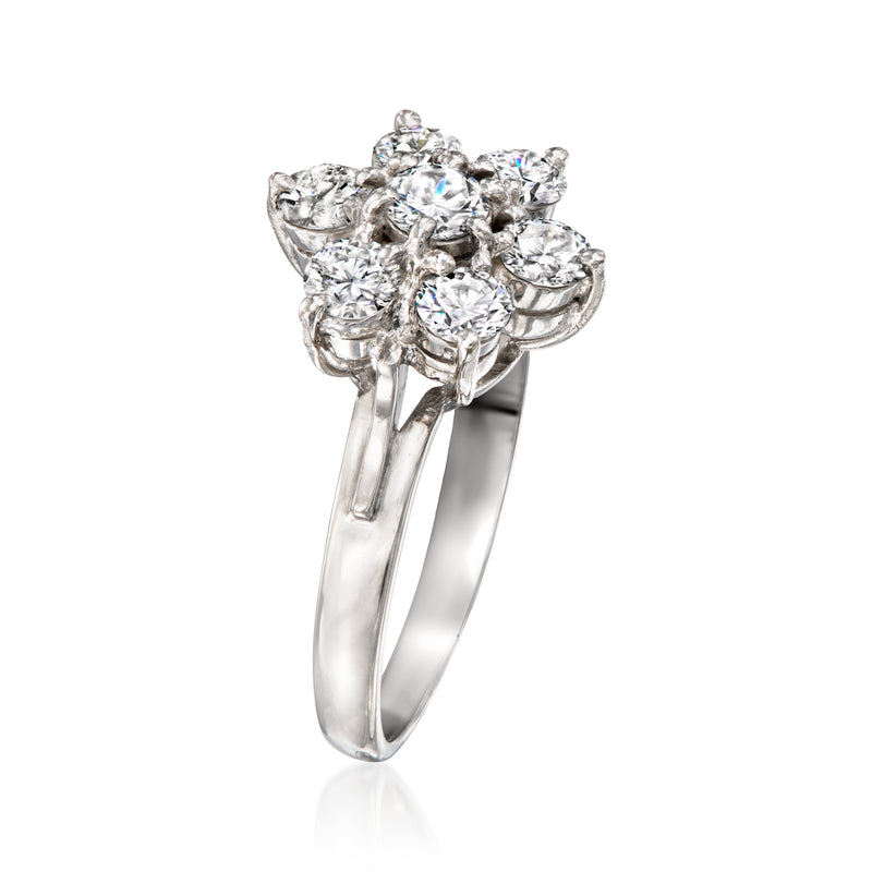 Platinum diamond flower ring with high-set clustered round stones, side view