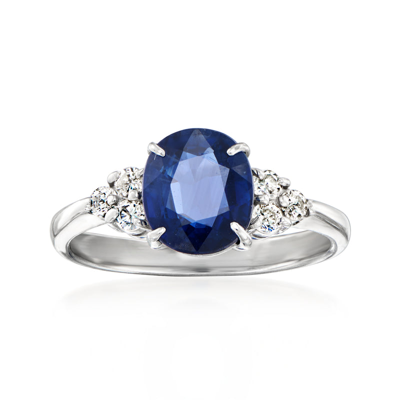 Platinum vintage sapphire ring with oval blue center stone and diamond halo accents