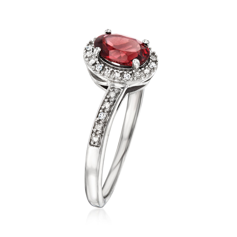 Sterling silver garnet ring with red oval center stone and side diamond accents