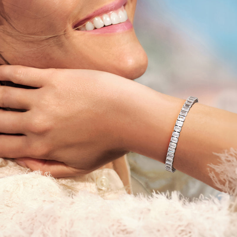 Sterling silver tennis bracelet with emerald-cut CZ stones on wrist