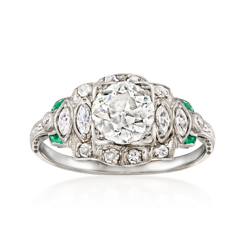 Platinum vintage diamond ring with round center stone and green synthetic emerald side accents