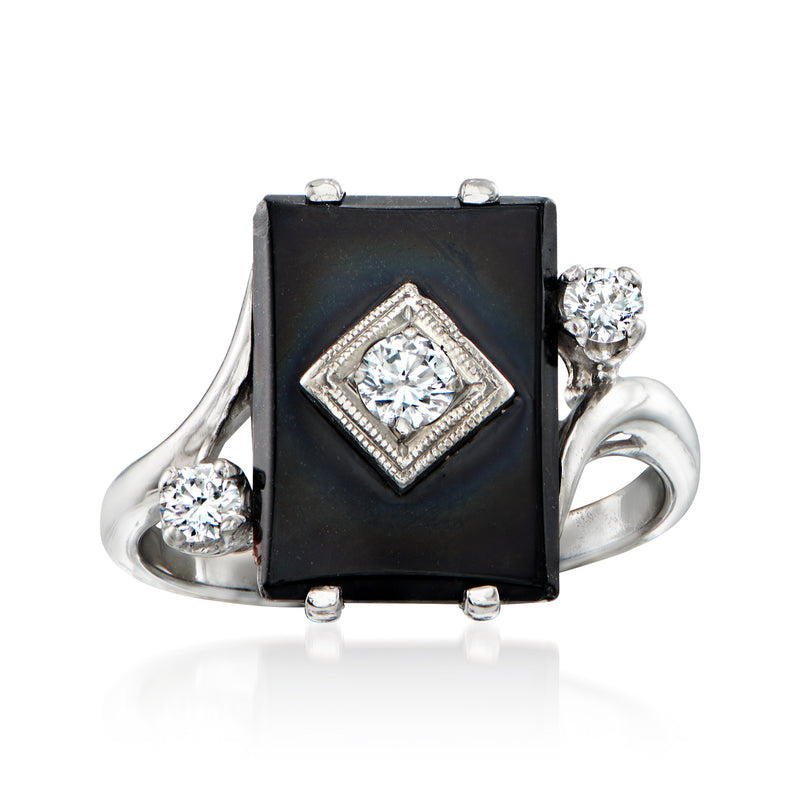 Vintage white gold ring with black onyx square center and round diamonds in halo, side stones.