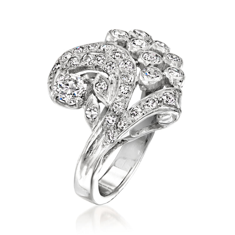 Platinum diamond cluster swirl ring with central round stone and halo bands