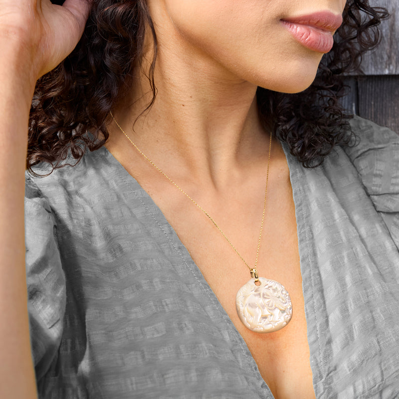 Mother-of-pearl elephant pendant on 14kt yellow gold chain, worn at collar