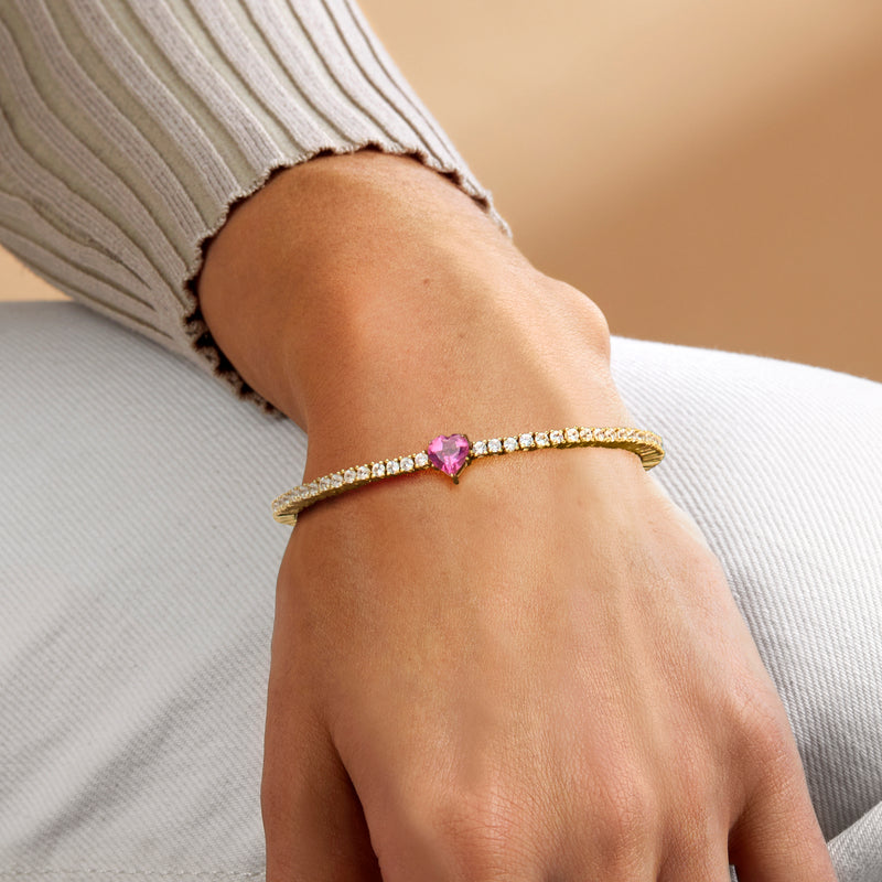 Gold over sterling tennis bracelet with pink heart-shaped center stone and white zircon accents