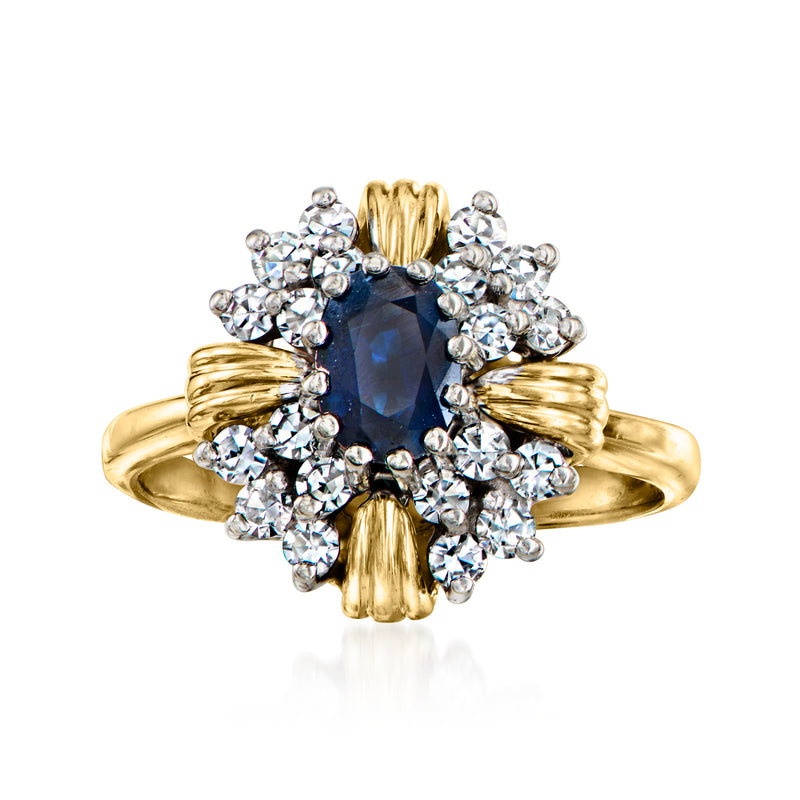 14kt yellow gold ring with dark blue sapphire center and halo of clear diamonds