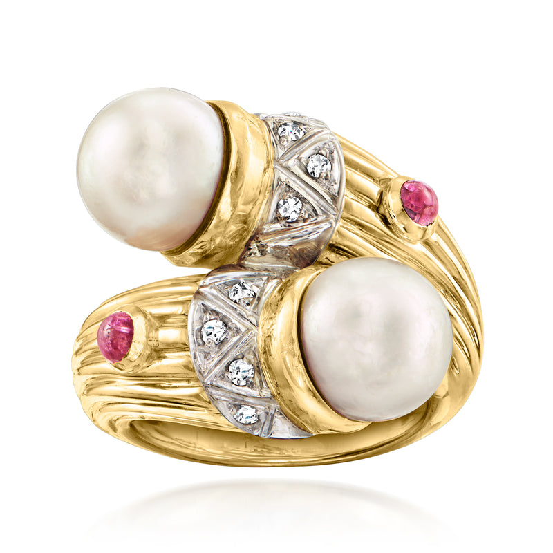 Two-tone gold bypass ring with two cultured pearl cabochons, diamond accents, and ruby stones