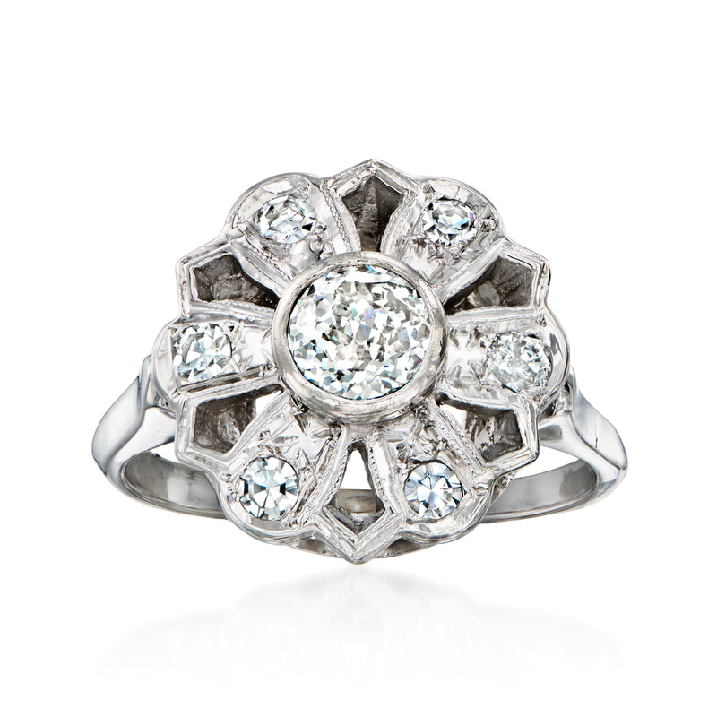 Vintage diamond flower ring in 14kt white gold with central round stone and side diamonds