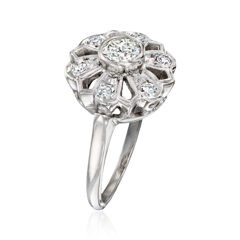 Diamond flower ring in 14kt white gold with round center stone and faceted openwork petals