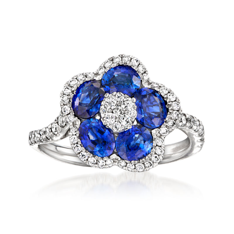 18kt white gold flower ring with oval blue sapphires and round diamond halo accents