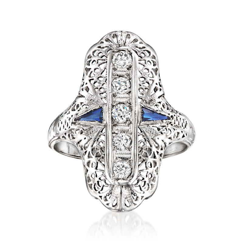 White gold filigree ring with blue center sapphire and clear stones