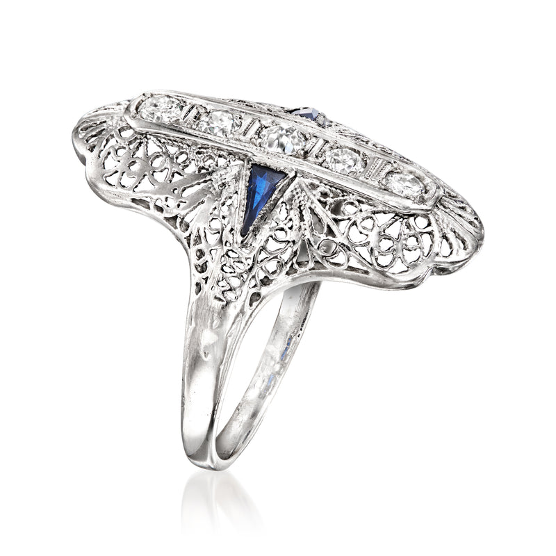 Side view: white gold filigree ring with blue sapphire and clear stones