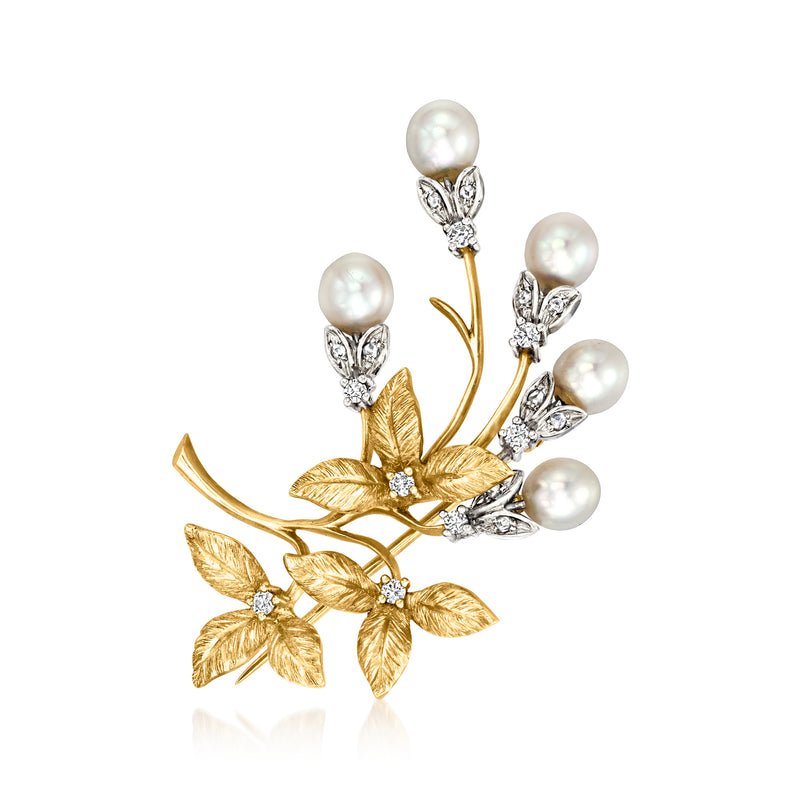 Gold bouquet pin with cultured pearls, leaf motifs, and small diamond-like accents.