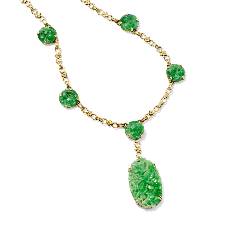 Carved green jade station necklace with dangling oval pendant on gold chain