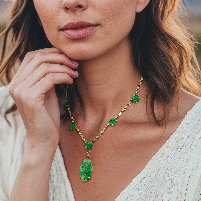 Green jade station necklace worn with oval drop pendant on 14kt yellow gold chain