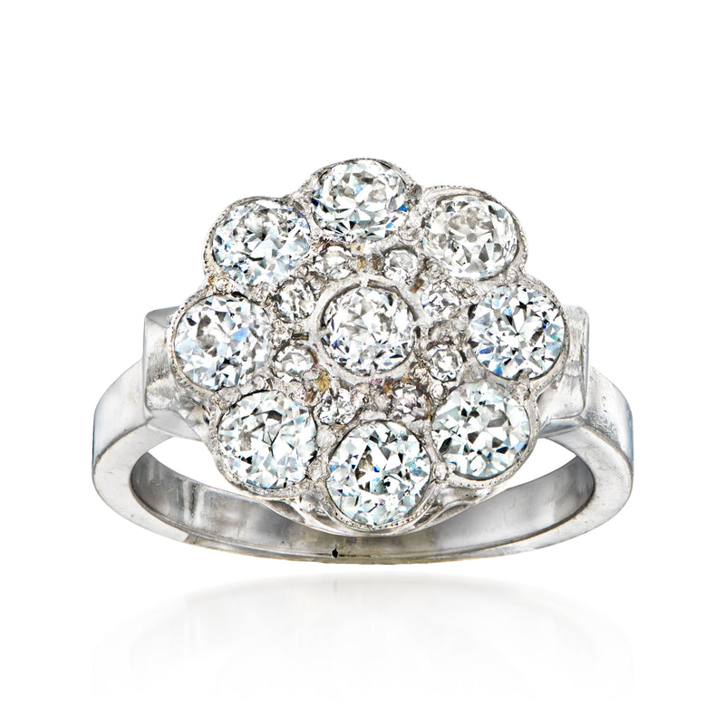 Vintage diamond flower cluster ring in 14kt white gold, oval and round stones.