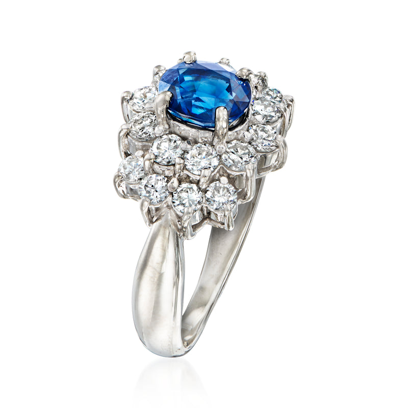 Platinum sapphire and diamond cluster ring, side view of oval blue center stone