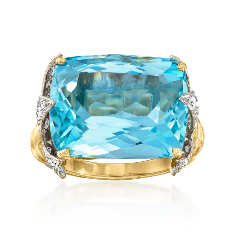 Aquamarine and diamond ring with large blue cushion stone in two-tone gold