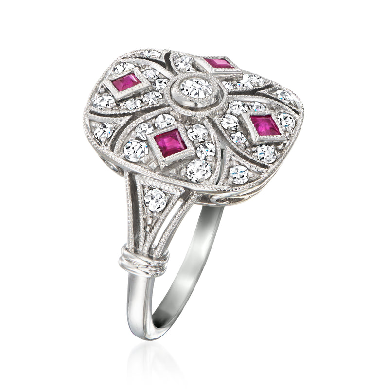 Side view of vintage filigree ring with clear stones and pink ruby squares, white metal band