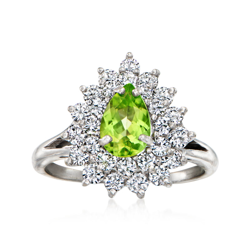 Peridot and diamond cluster ring in 18kt white gold, oval green center with round halo